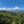 Scenic view of green hills and valleys under a blue sky with clouds.