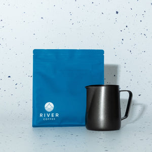 Blue coffee bag and black mug on a light speckled background